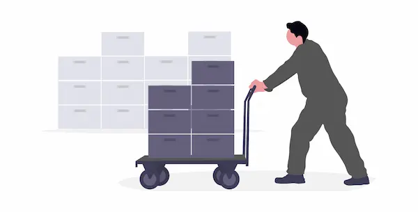 重い荷物を台車を使って運搬する人物のイメージ画像